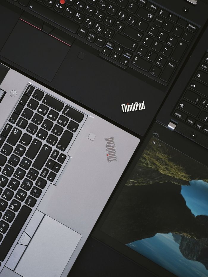 Services Close-up of modern ThinkPad laptops showcasing sleek design and technology.